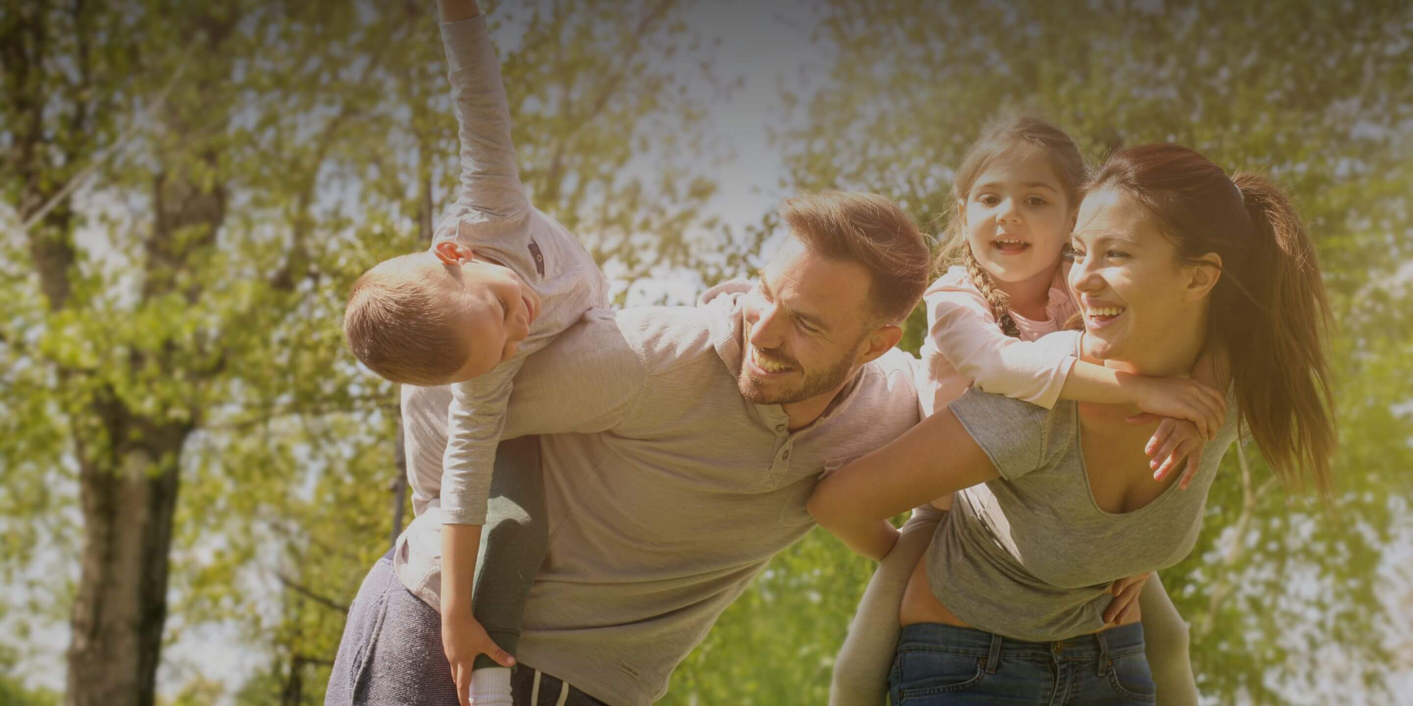 A group of people that are standing in the grass.
