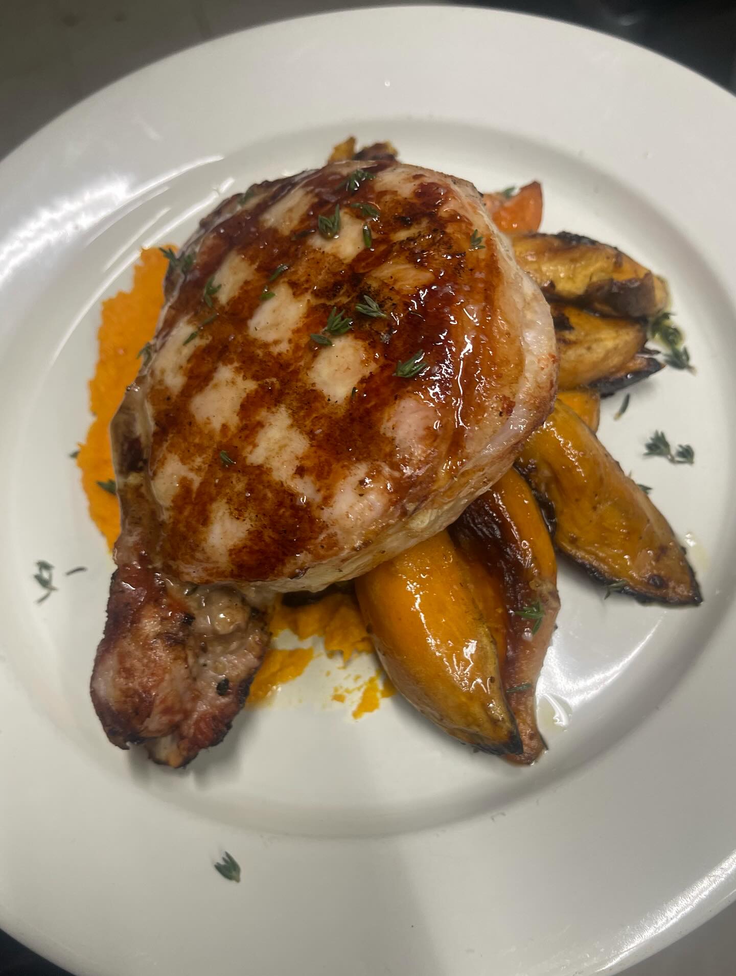 A plate featuring grilled chicken alongside a colorful assortment of sautéed vegetables.