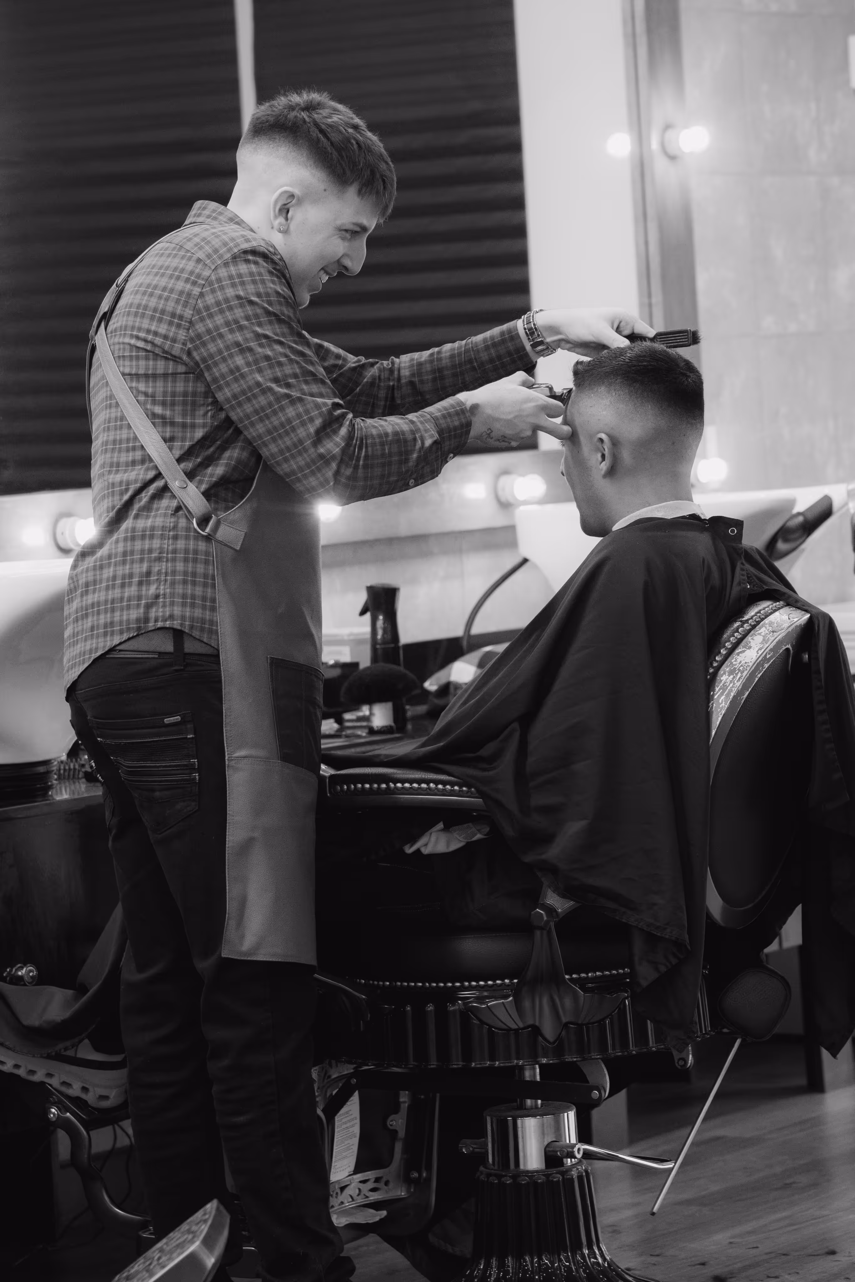 Picture of man sitting in a barber chair getting his hair trimmed