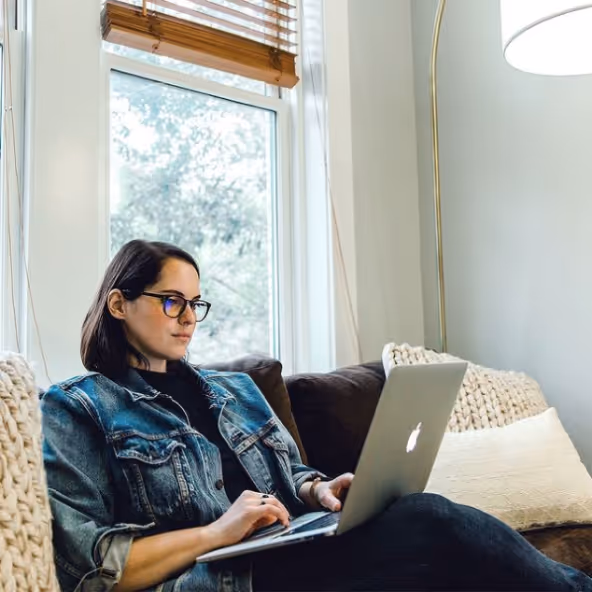 A woman looking at a laptop 