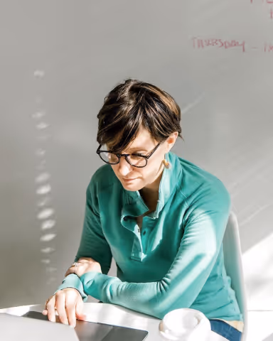 A woman looking at a laptop