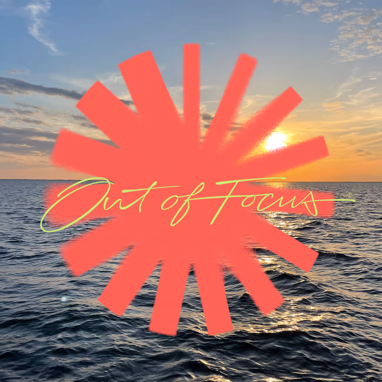 Ocean waves at sunset with a bright sun near the horizon and a red splash graphic with 'Out of Focus' text overlay.