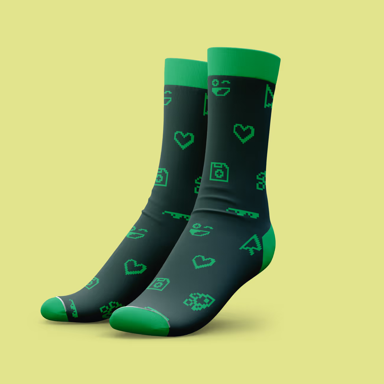 Pair of black socks with green pixelated gaming icons and green cuffs, heels, and toes.