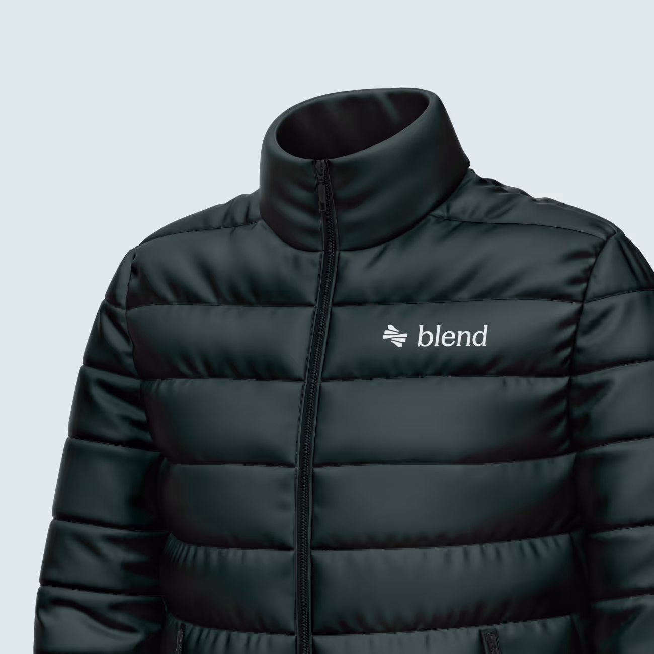 Close-up of a black puffer jacket with a stand-up collar and 'blend' logo on the chest.