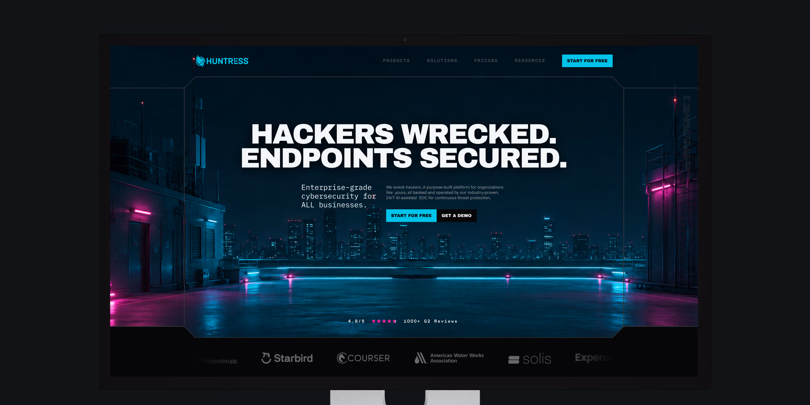 Cybersecurity website homepage with text 'Hackers wrecked. Endpoints secured.' and cityscape background.