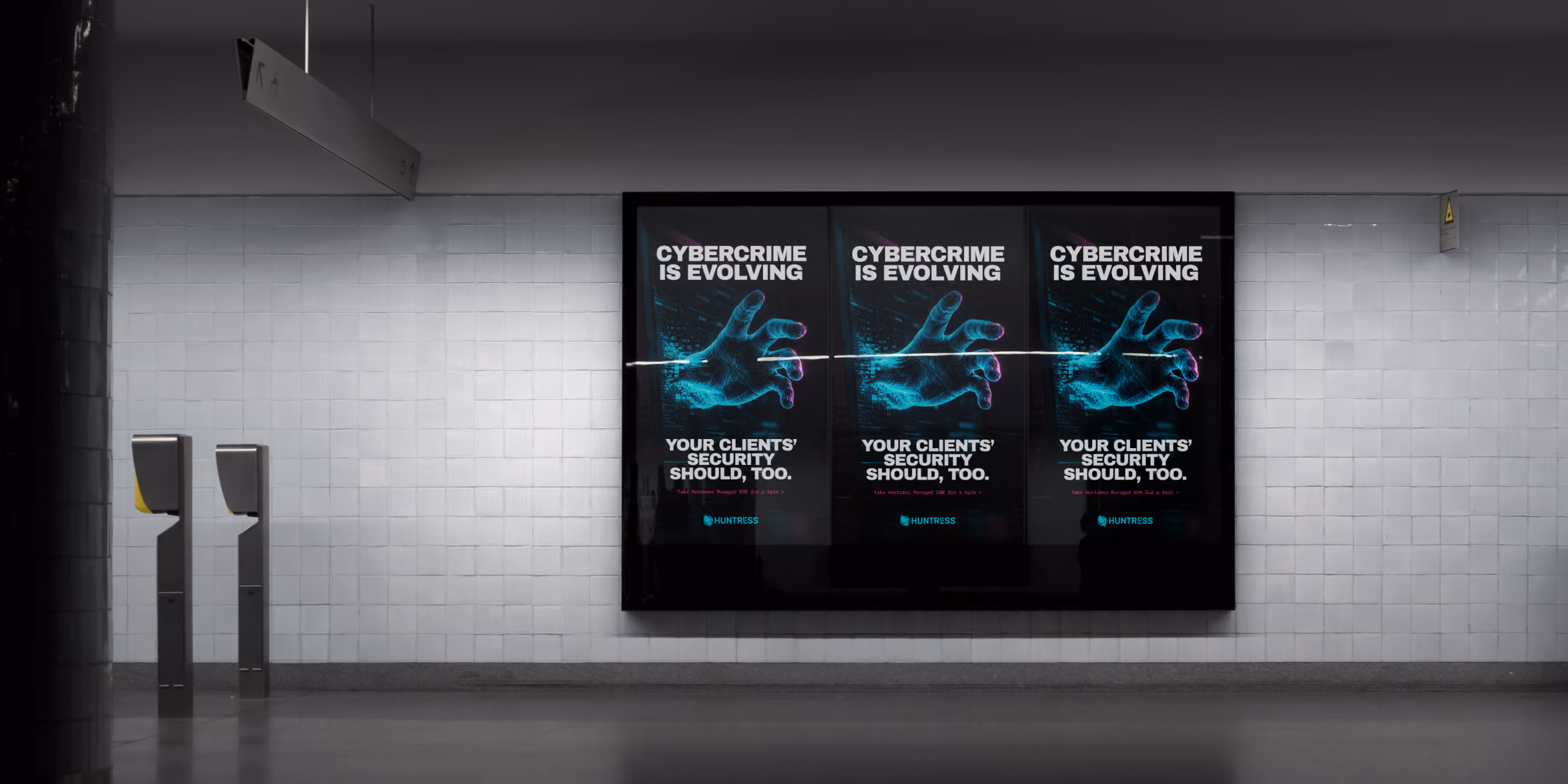 Three digital posters in a subway say 'Cybercrime is evolving. Your clients' security should, too.'