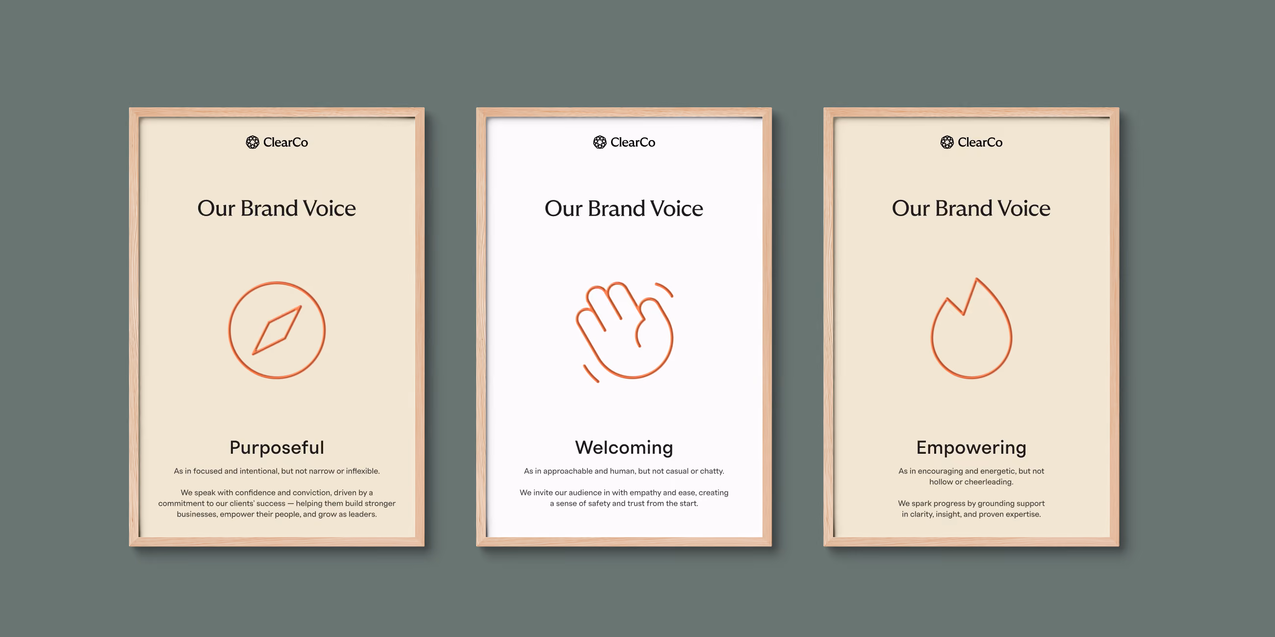 Three framed posters with ClearCo logo and the title Our Brand Voice, each highlighting a different value: Purposeful with an orange compass icon, Welcoming with an orange waving hand icon, and Empowering with an orange flame icon, accompanied by brief descriptive text under each value.