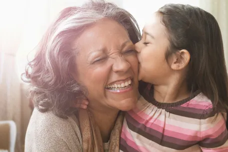 A picture of a Grandmother and  granddaughter sharing a cheerful moment