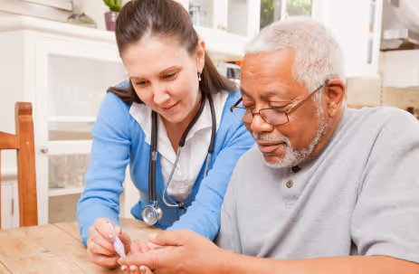 A picture of a caregiver helping an elderly person