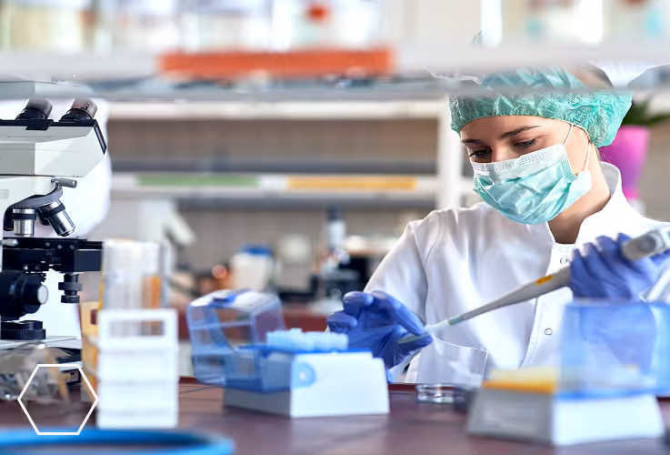 A Photograph of a  medical lab researcher loading a slide to view on a microscope