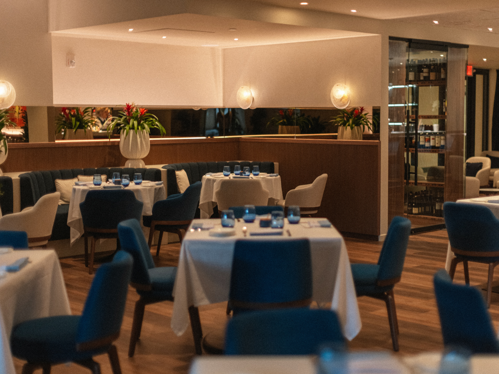 Restaurant interior with blue chairs and white tablecloths