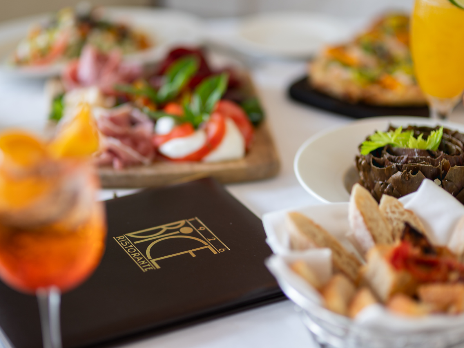 Menu, drinks and appetizers on a restaurant table