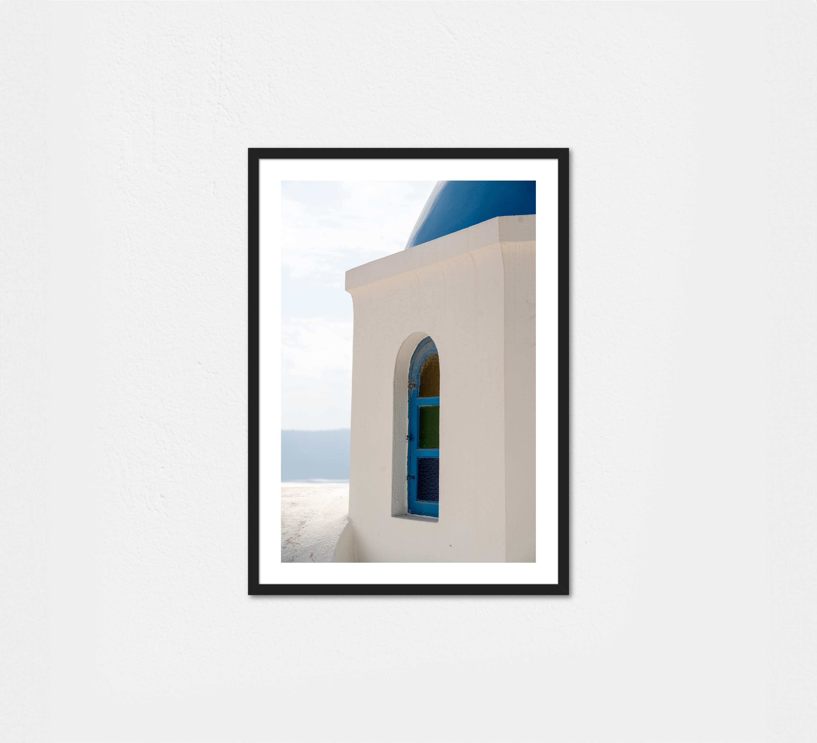 A quiet corner in Santorini, where soft light meets whitewashed walls and sea-blue trim.