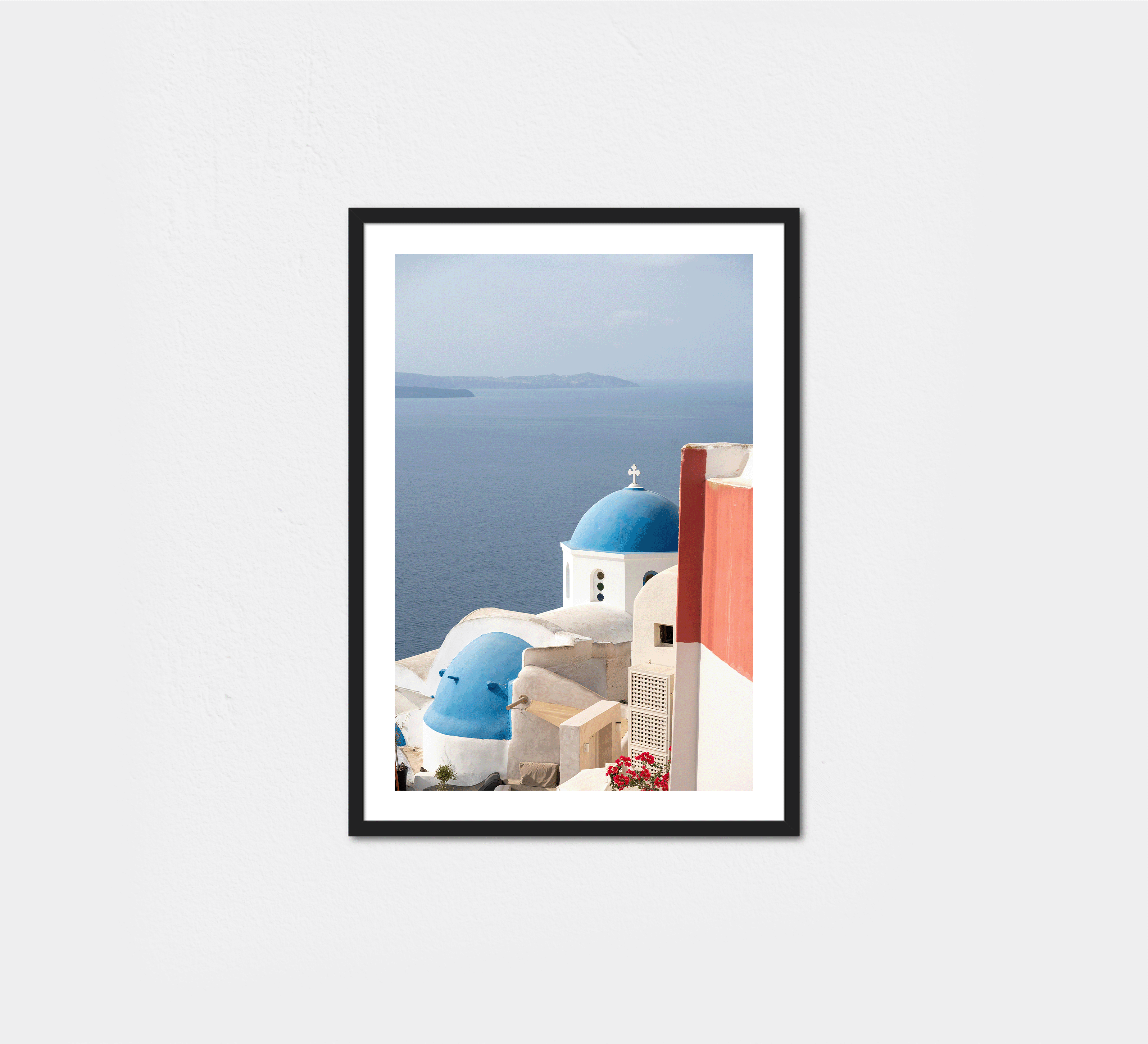 The iconic blue domes of Santorini overlook the endless Aegean, capturing the timeless serenity of the Greek islands.