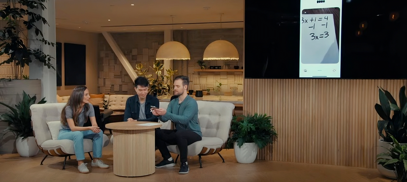 OpenAI's CTO and 3 engineer leads sit on a beige stage at a demo at a launch. The screen behind them shows a phone taking an image of a written math equation.