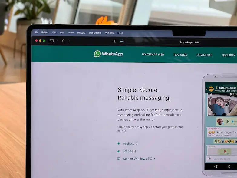 A laptop screen opened to messaging service WhatsApp.