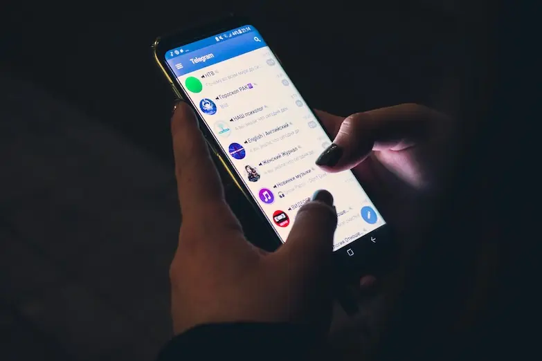 A smartphone opened to the messaging service Telegram displayed in Russian.