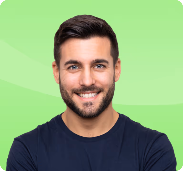 Smiling man with short dark hair and beard wearing a navy blue shirt against a light green background.