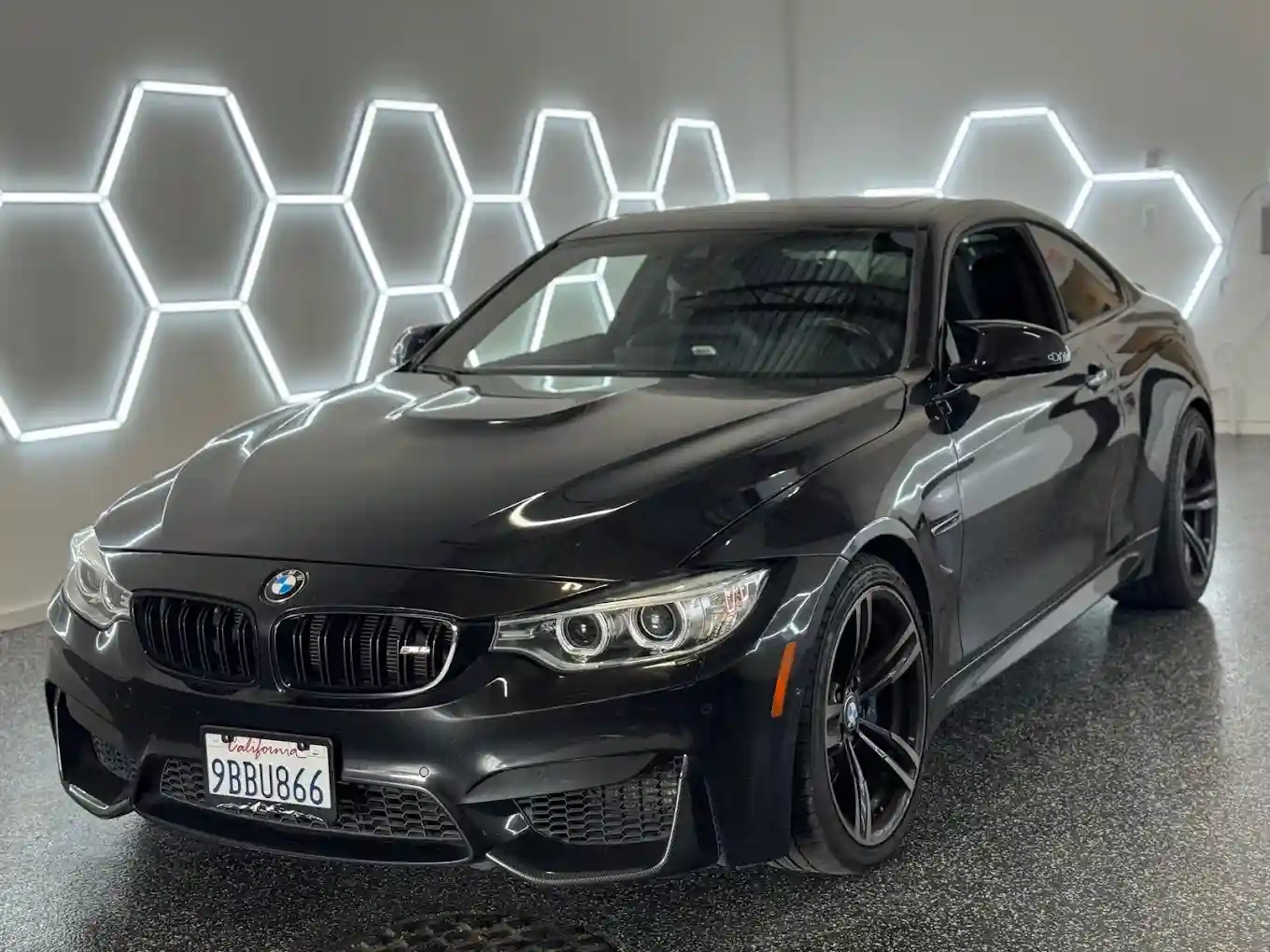 Black BMW vehicle photographed inside Crown Auto Glass shop