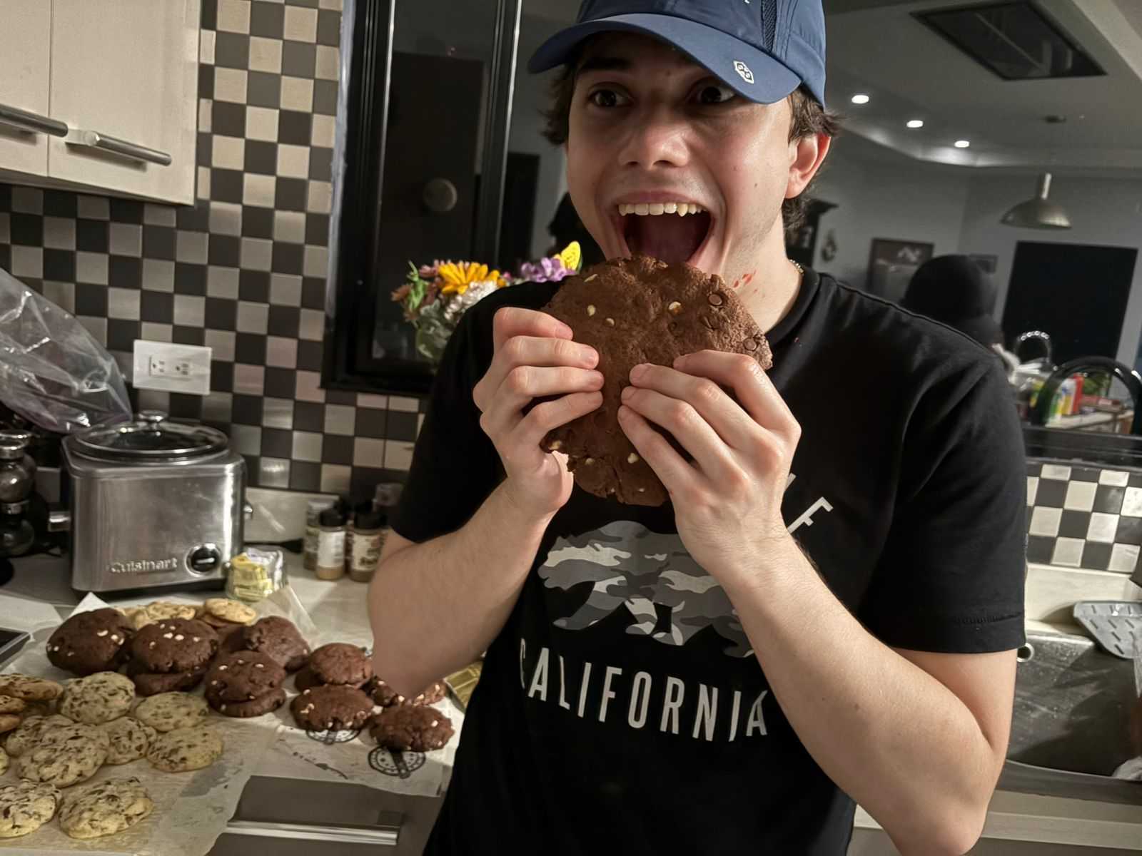 Kenneth, AI engineer at CRSS, enjoying a cookie at home in a relaxed moment.