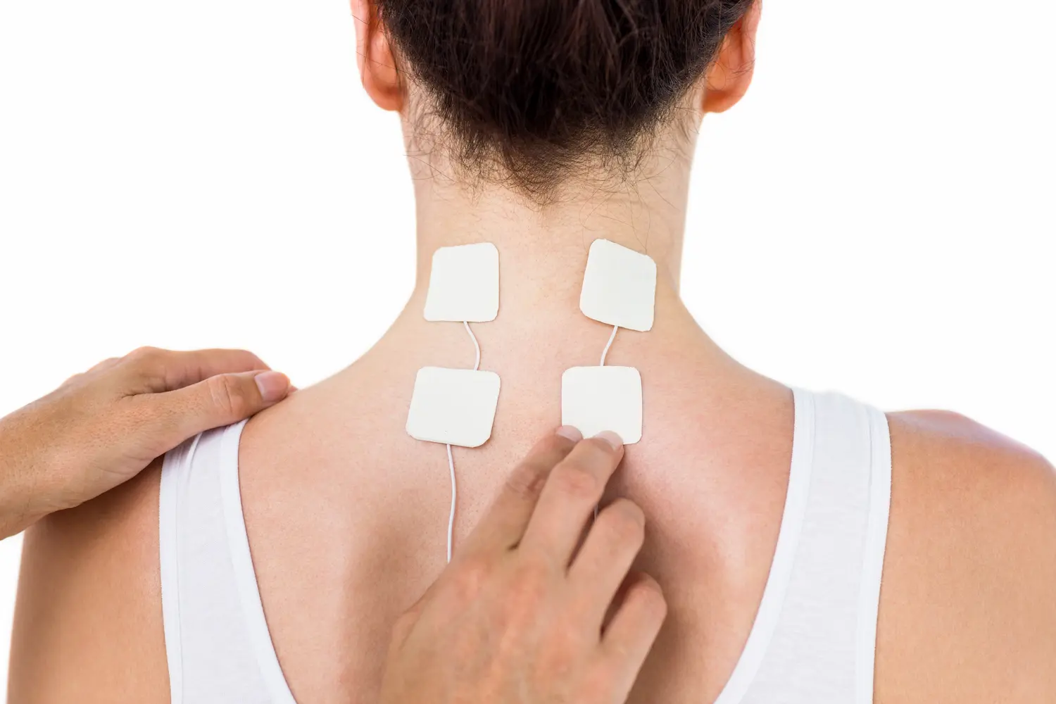 Woman receiving shockwave therapy with four adhesive electrodes on her upper back for pain relief.