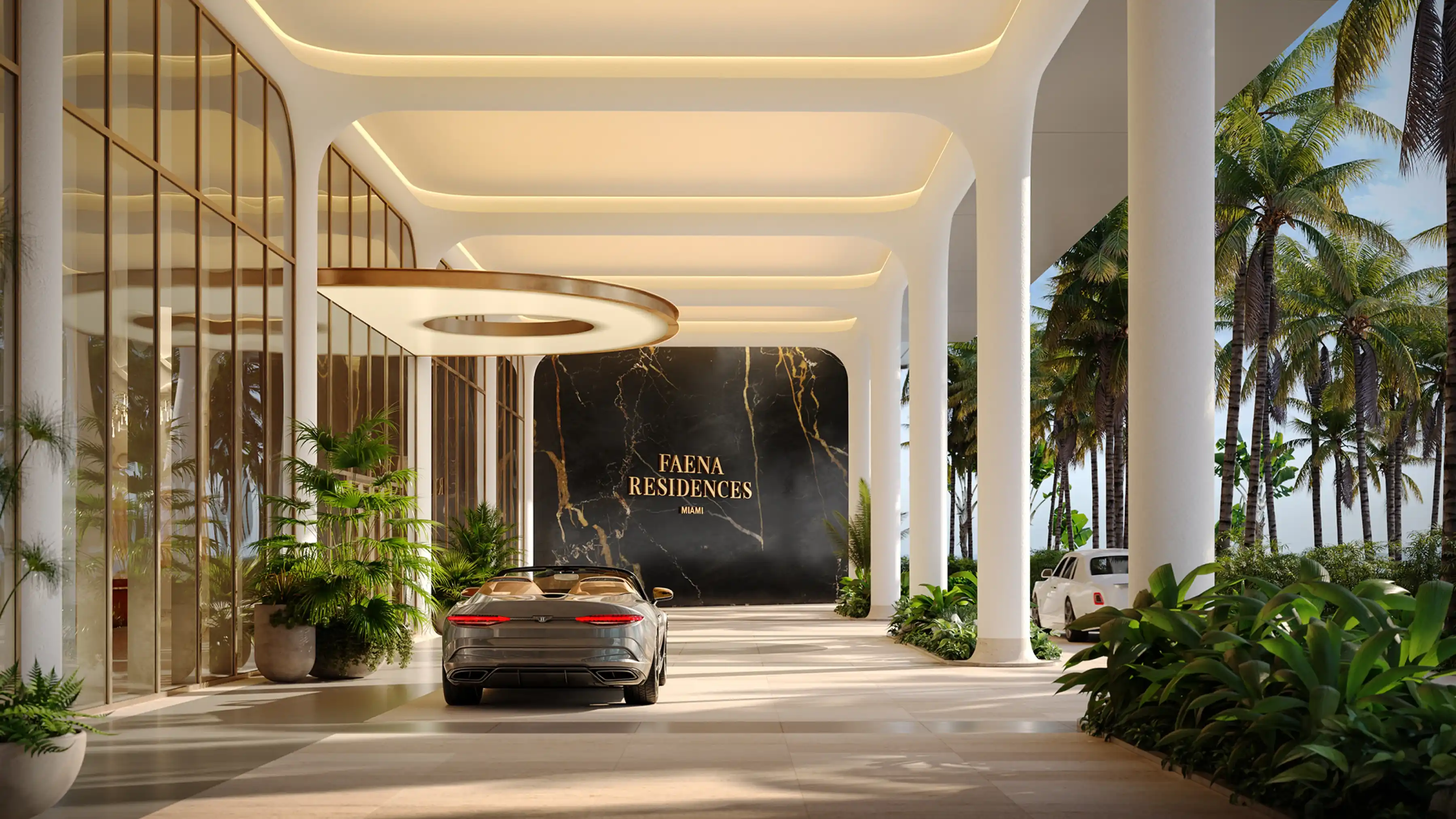 Covered arrival driveway surrounded by palm trees and luxury architectural lighting at Faena Residences Miami.