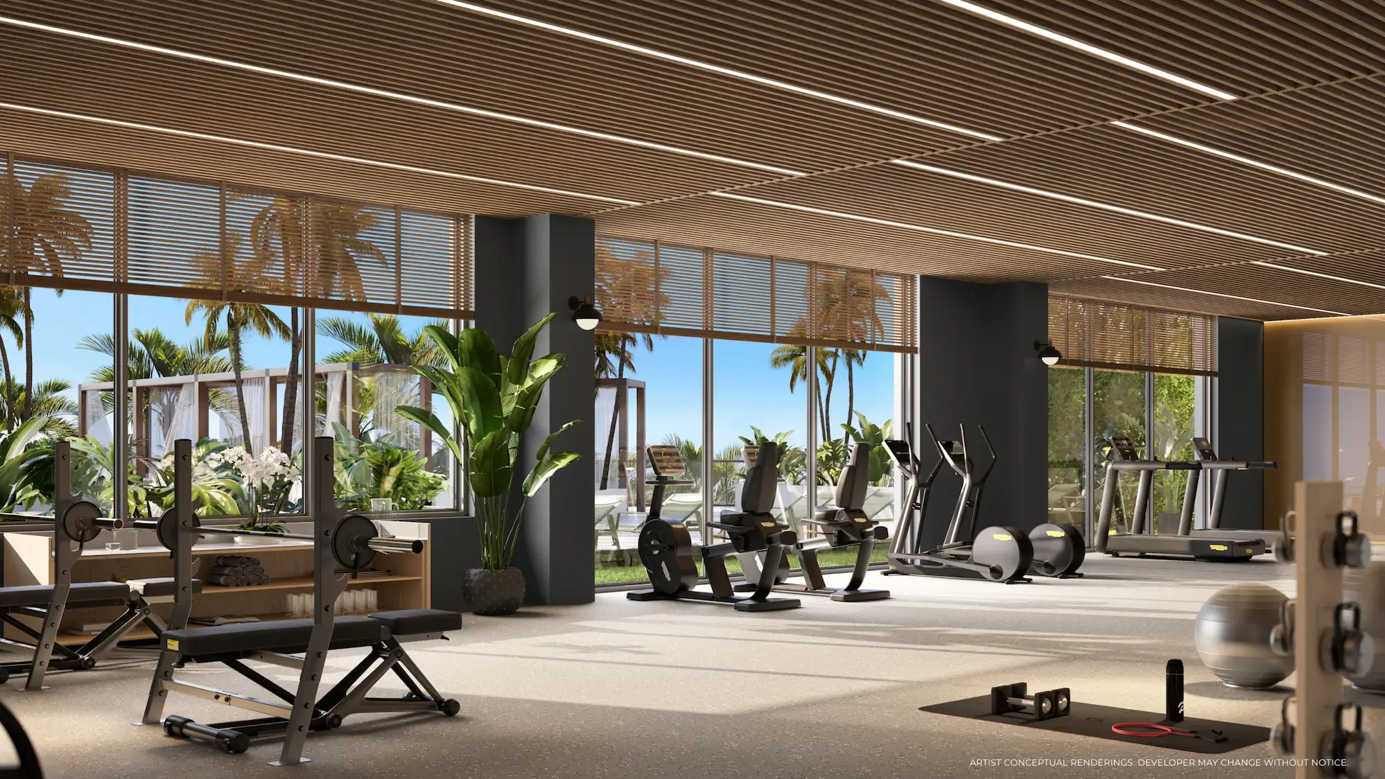 Luxury fitness center with floor-to-ceiling windows and tropical outdoor views at Palma Miami Beach.