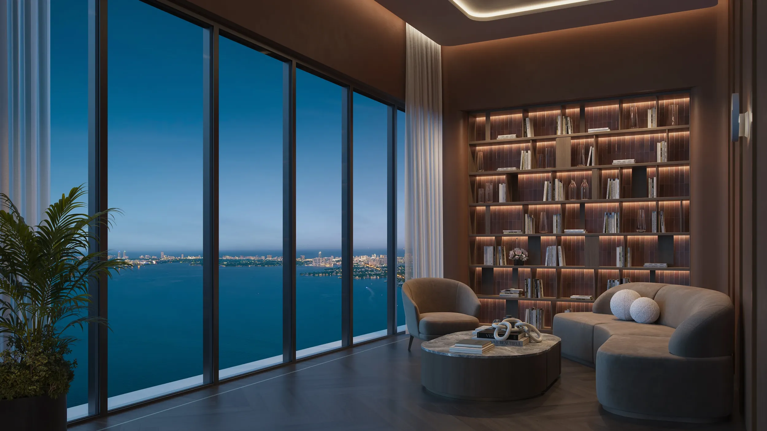 Library-style lounge with cozy seating and panoramic city views at Edge House Miami.