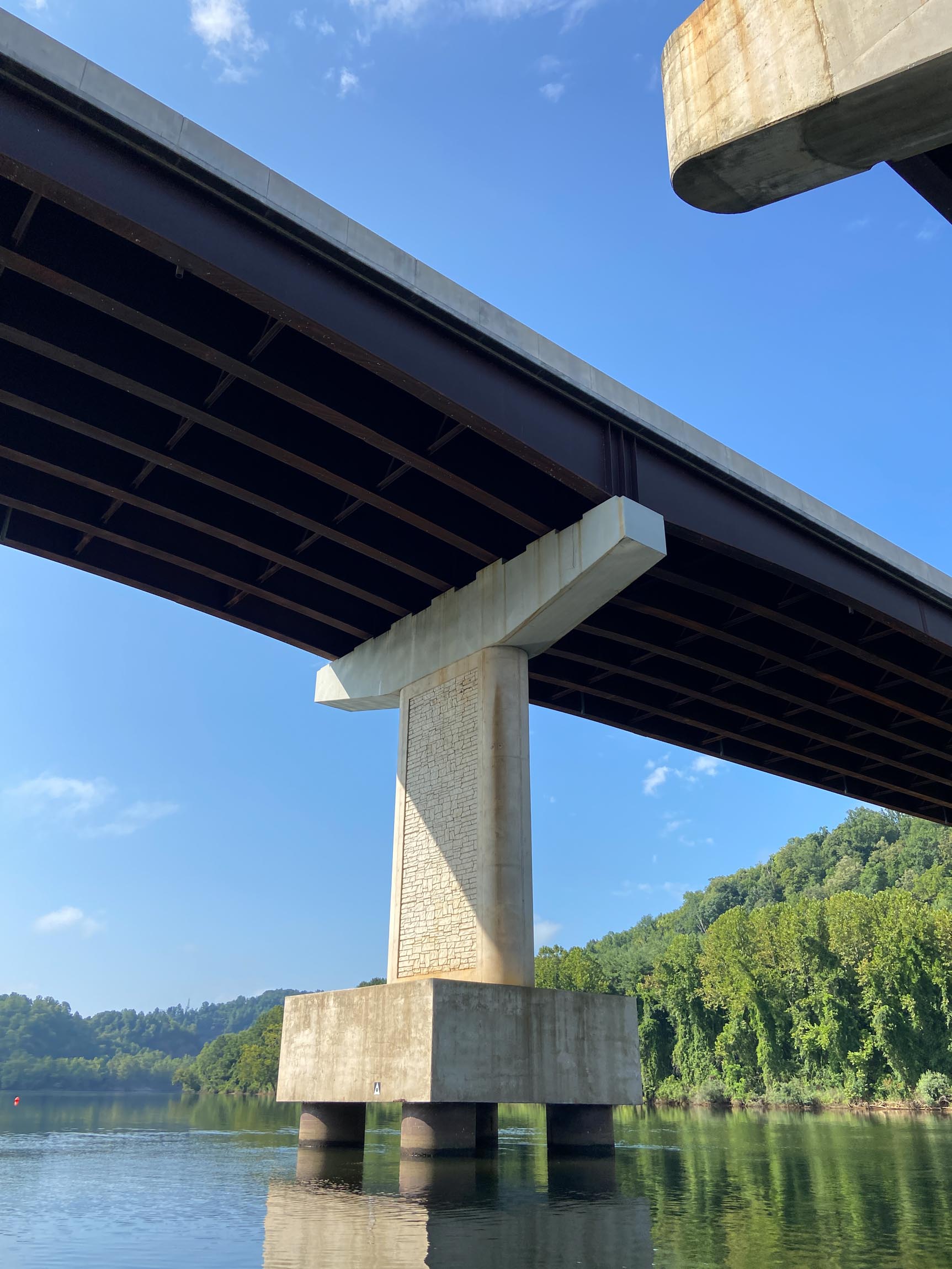 view of a bridge pillar from the surface of the water.