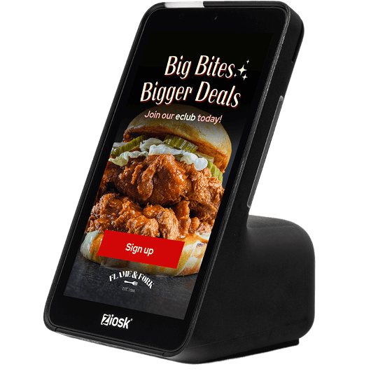 Ziosk tabletop touchscreen device displaying a promotion for Flame & Fork with fried chicken sandwich and a red sign-up button.