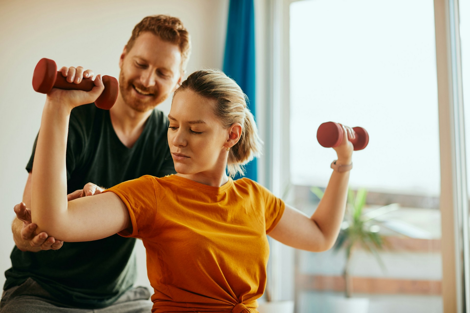 woman doing small weight physiotherapy