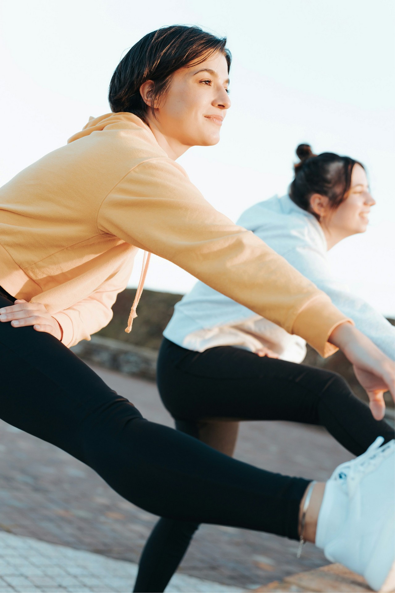two people stretching before a run