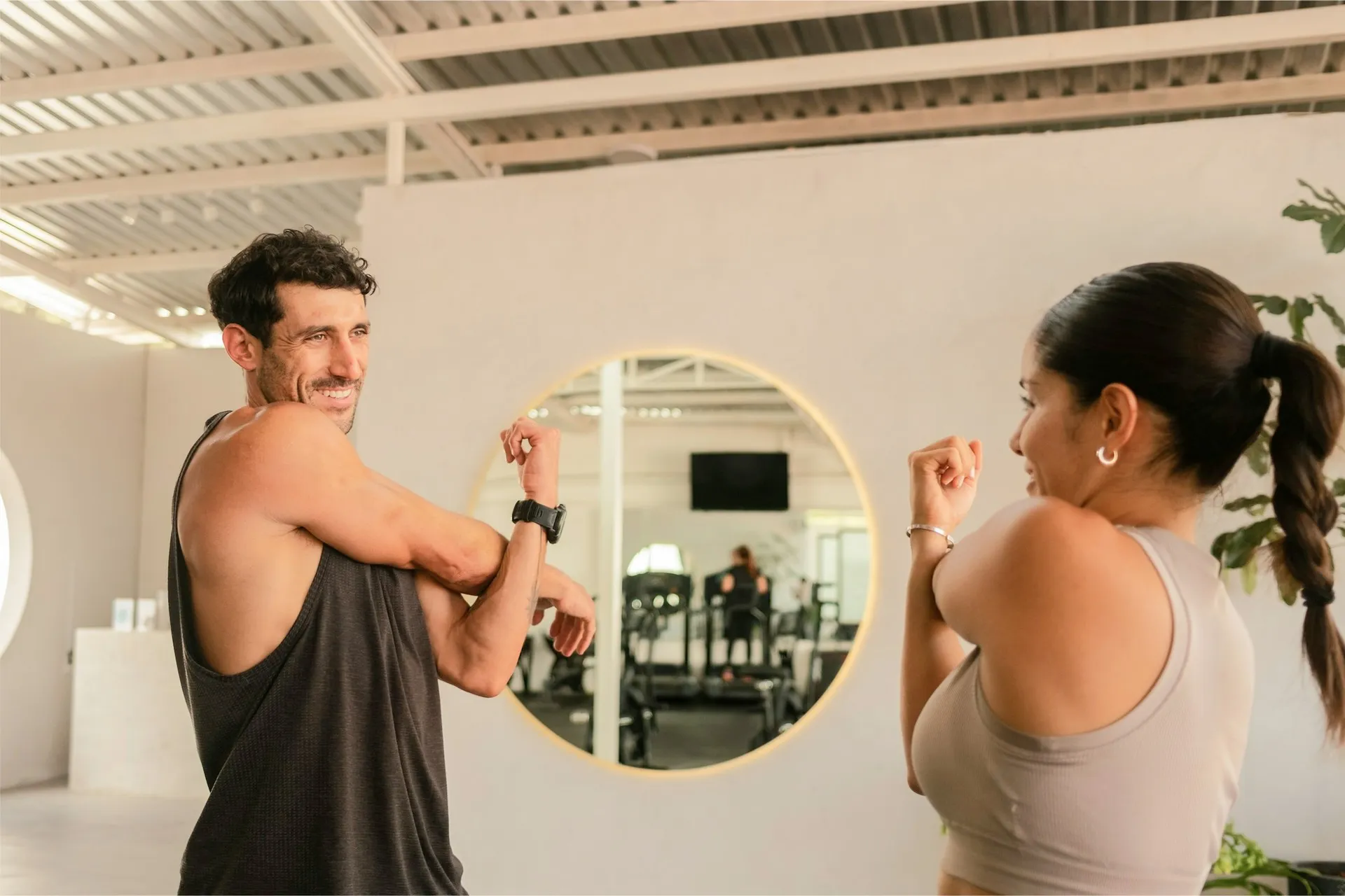 two people stretching in front of a mirror before physiotherapy