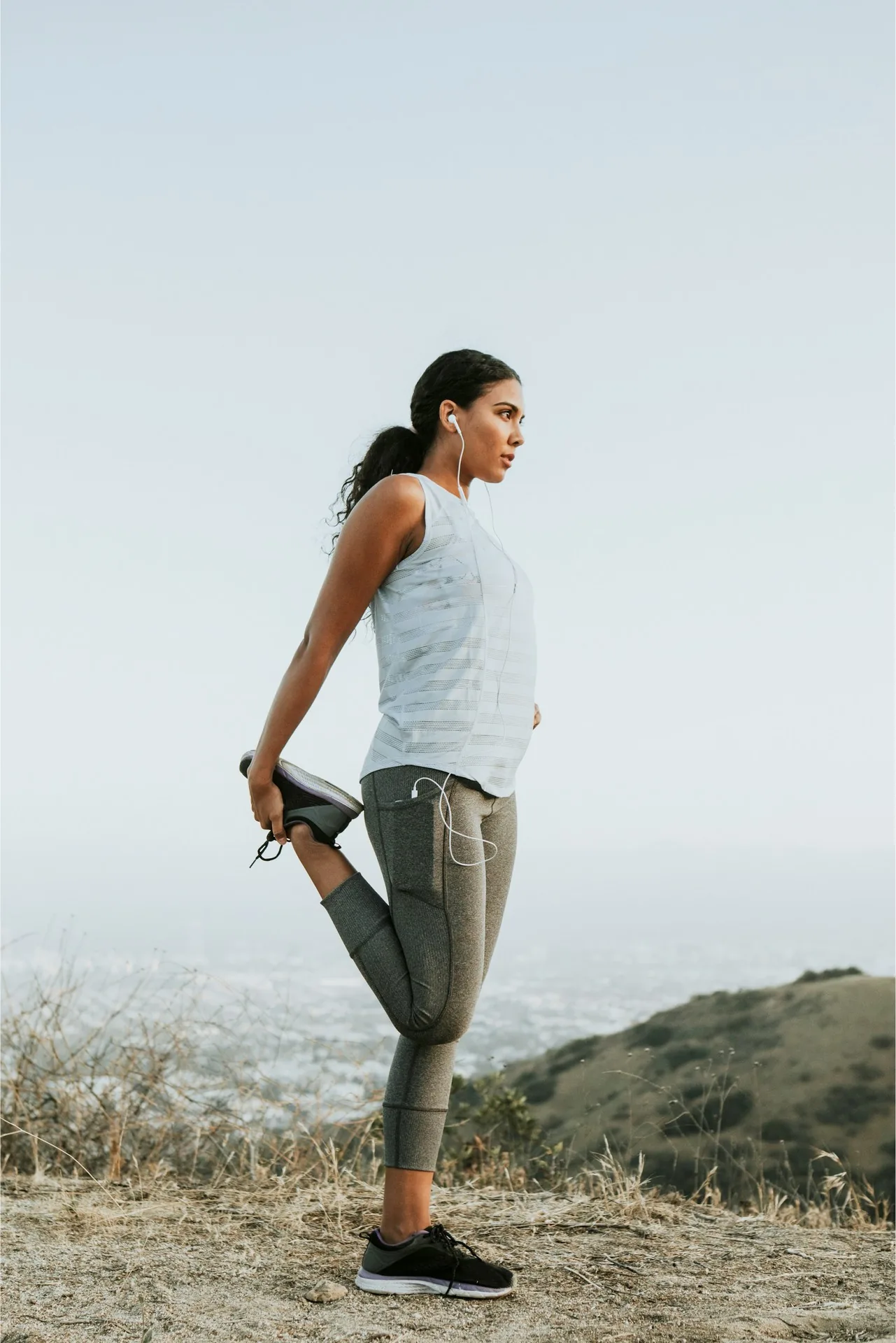 Woman doing a standing quadriceps stretch