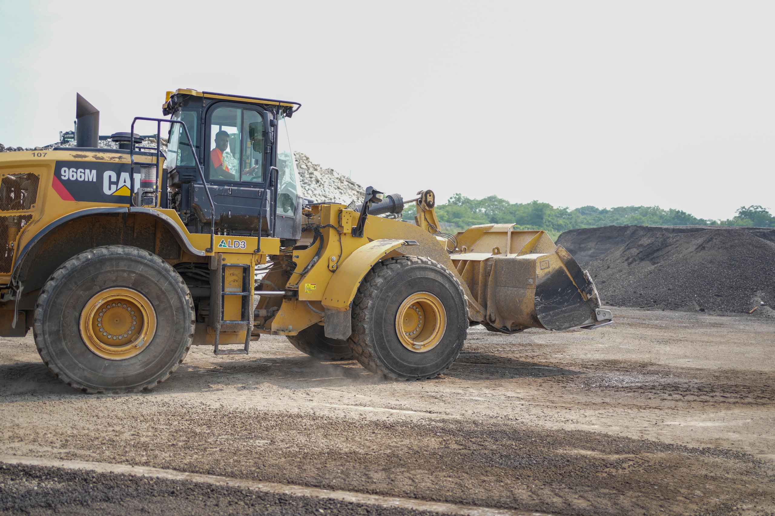 Photo of a construction worker sitting in a loader and looking at the camera, representing the confidence, skill, and approachability of Ontario contractors supported by ER Media.