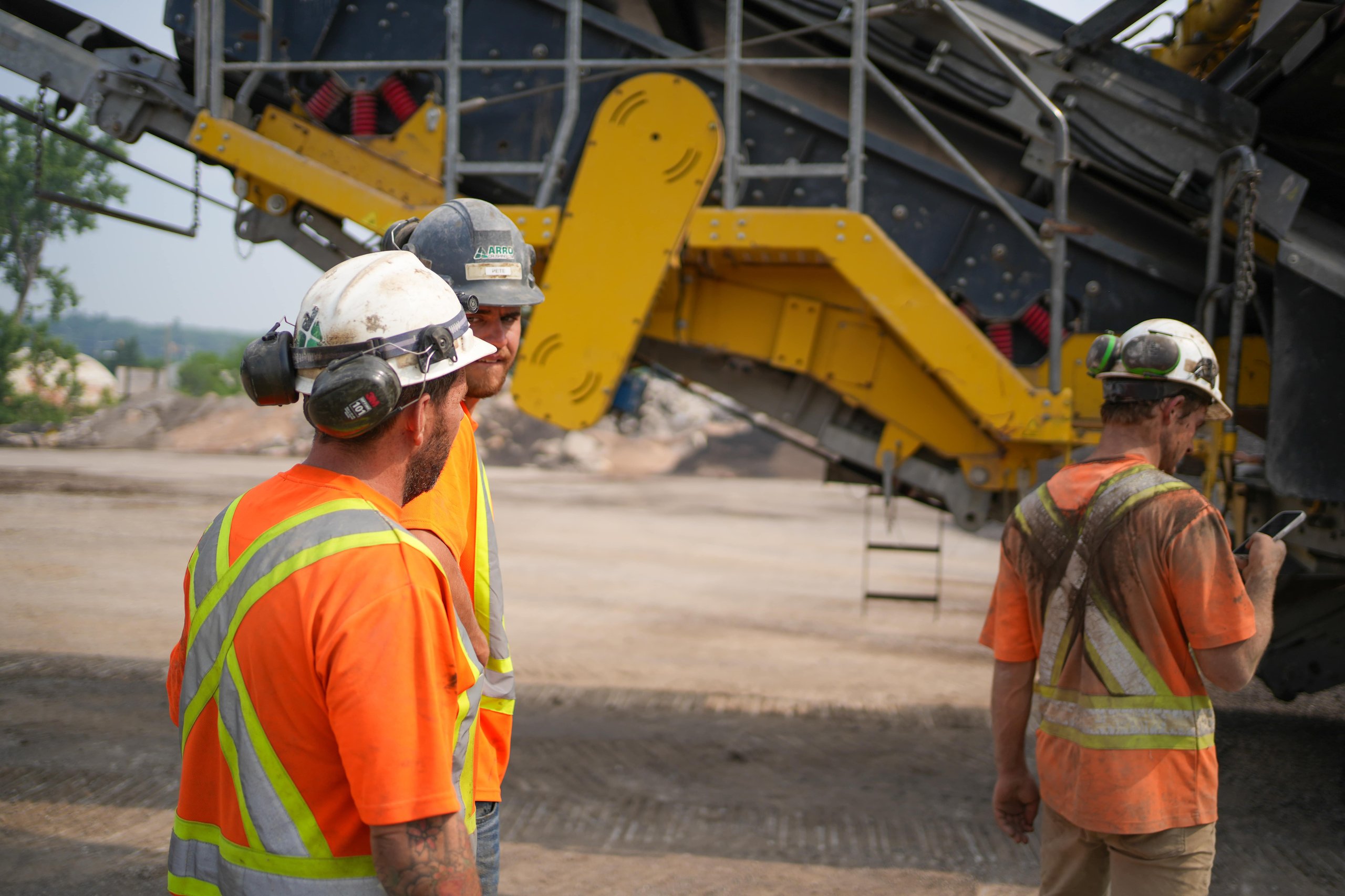 Photo of three construction workers on a job site, representing teamwork and real-world industry experience at ER Media.