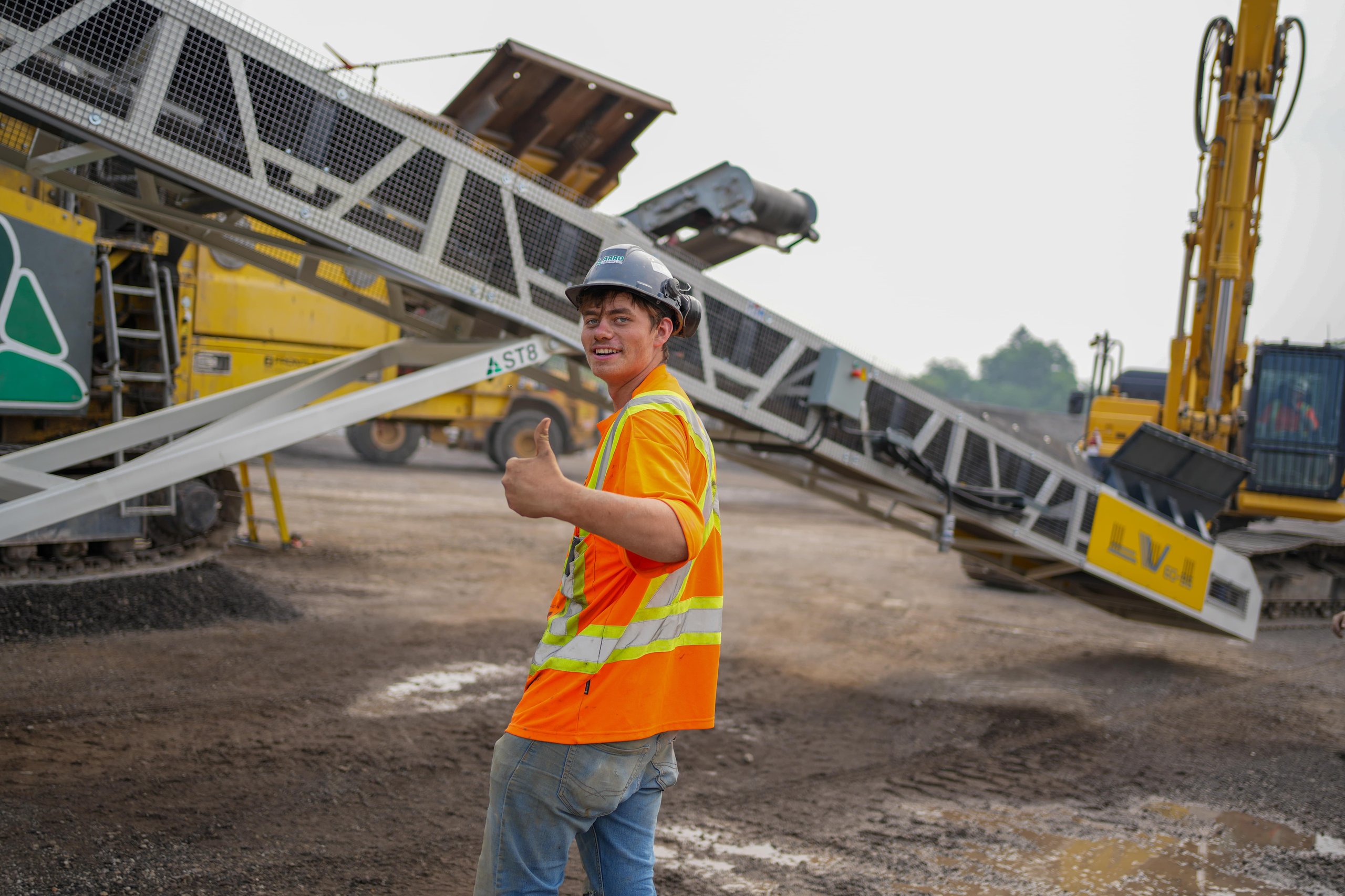 Photo of a construction worker smiling at the camera, representing the positive and welcoming team culture at ER Media for Ontario contractors.