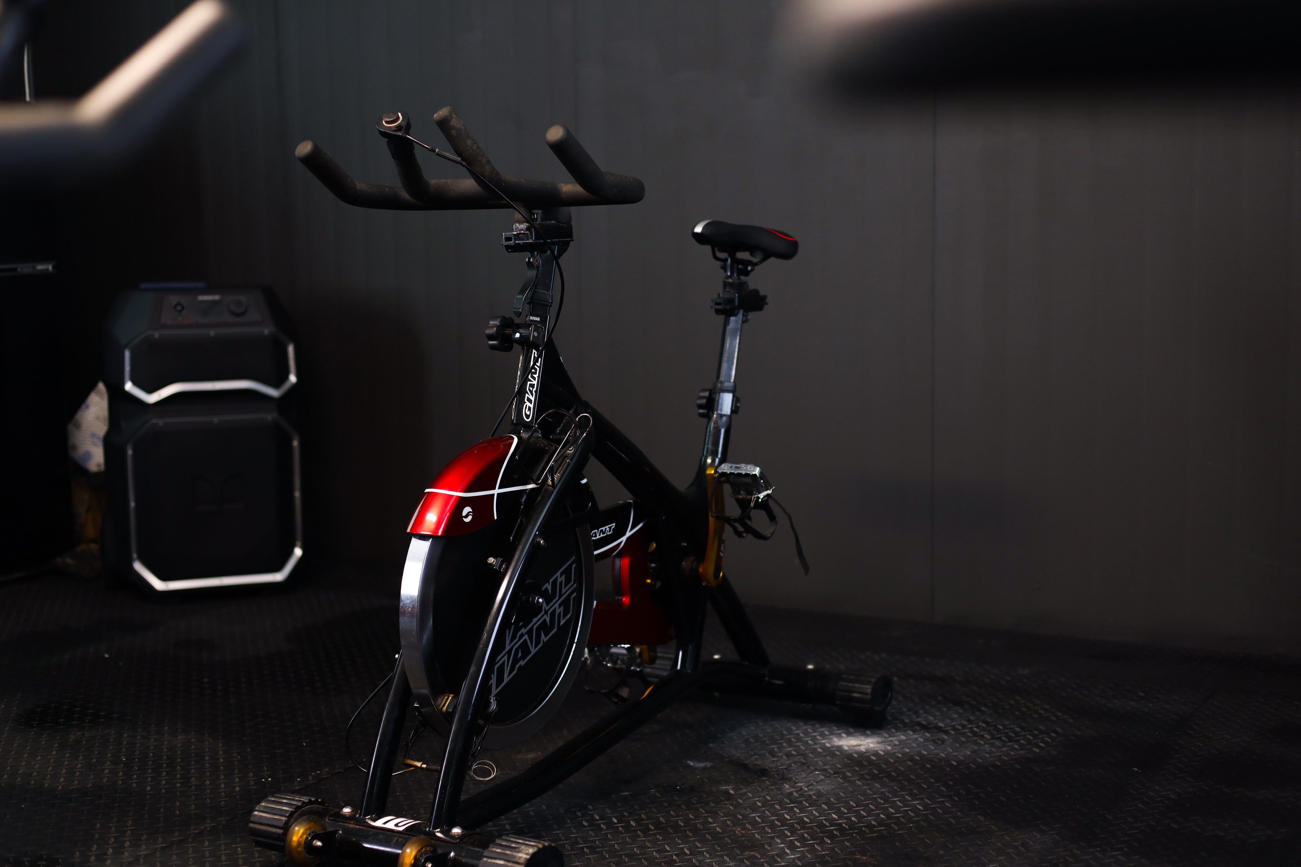 Burger with fried fries on black plate with sauce on the side