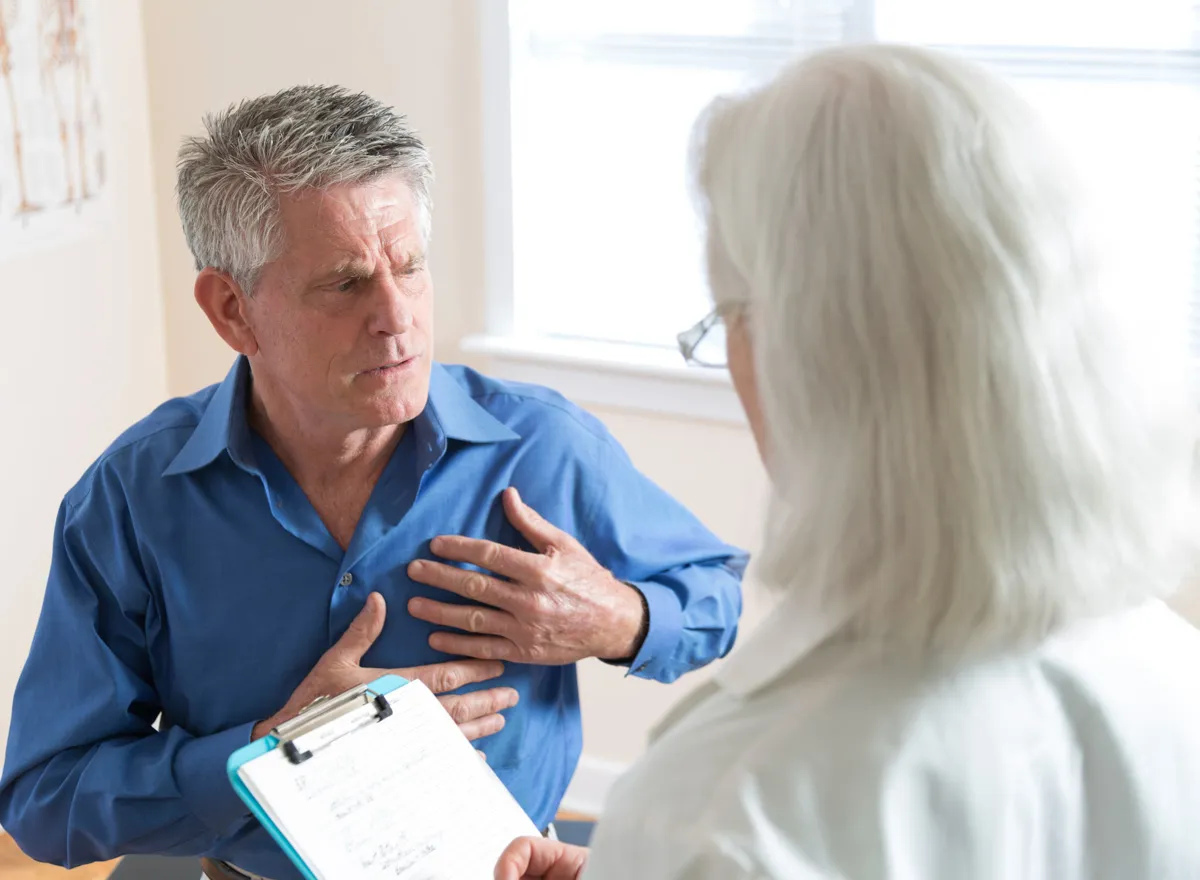 A patient describing his chest pain to a doctor