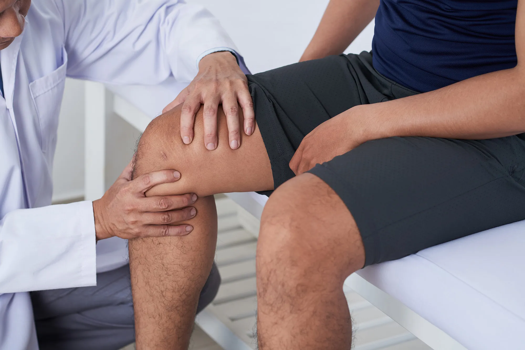 A doctor testing a patient's knee