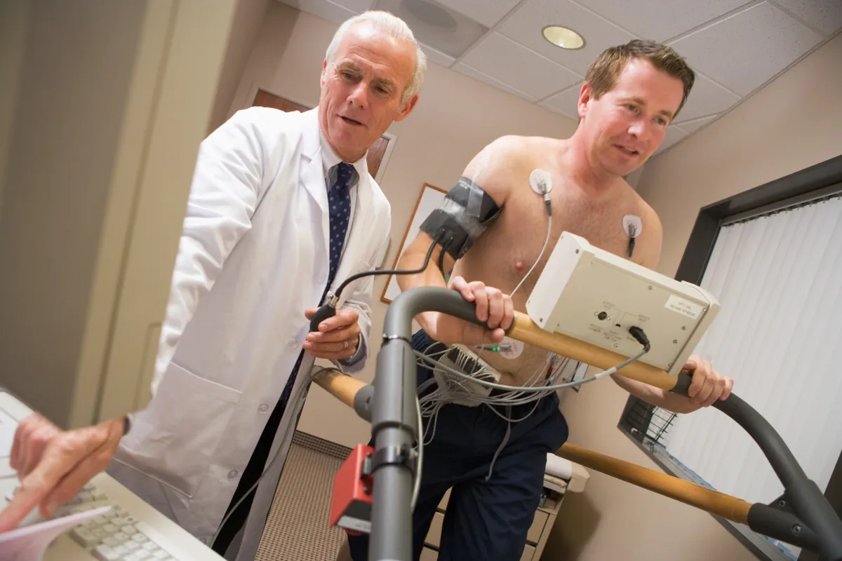 A doctor helping a patient with Cardiac Stress Testing