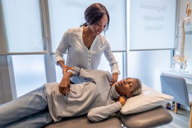 Chiropractor treating her patient