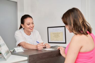 Woman making a payment at the receptionist
