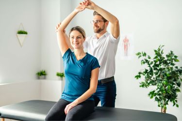 Woman with a better arm movement after seeing the chiropractor