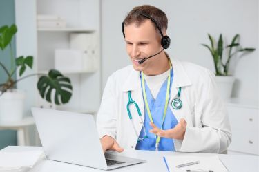 Doctor chiropractor on a videocall with a patient.