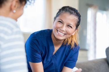 Office assistant smiling to a patient