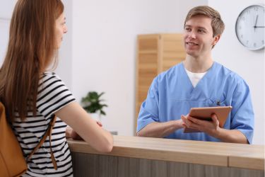 Office staff talking to patient