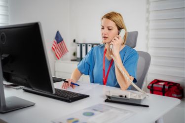 Medical assistant calling patients.