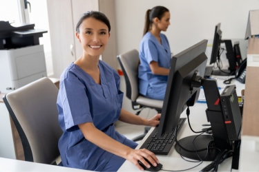 Two medical staff working on their computers