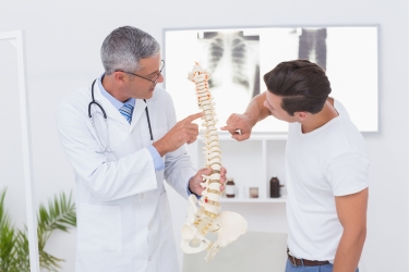 Chiropractor talking to his patient